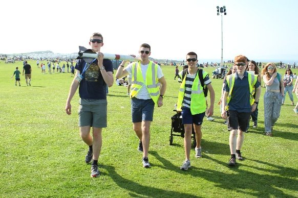 The four-person team carrying Triton II and equipment across the airshow grounds